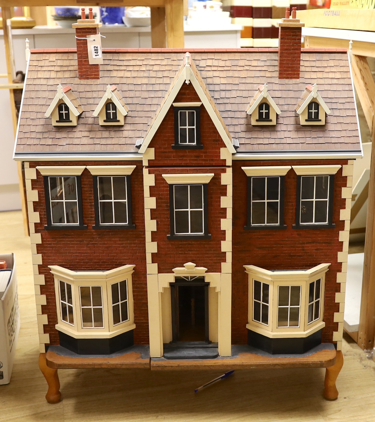A mid 20th century doll's house and contents, 84cms x 100cms high
